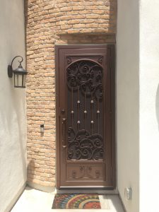 Decorative wrought iron security door secures a home's front entrance.