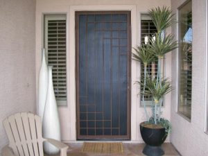 Decorative security doors with a contemporary style at a home's front entrance.