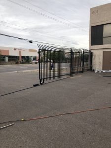 A wrought iron commercial security gate protects a business while providing access control.