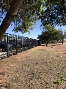 Wrought iron commercial security fencing protects a business.