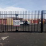Wrought iron rolling security gate secures a self-storage facility