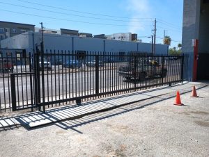 Wrought iron rolling gates secure commercial property in Phoenix, Arizona.