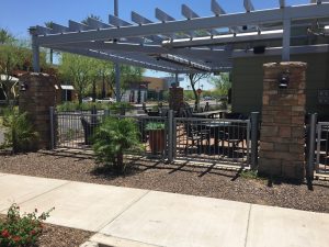 A Phoenix-area restaurant has a patio enclosed by wrought iron restaurant patio fencing.